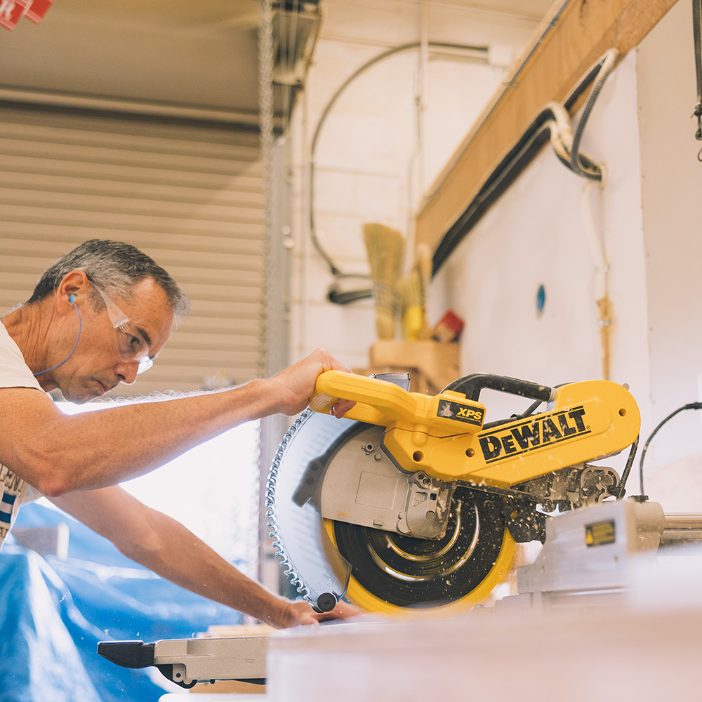 Caucasian man using a table saw