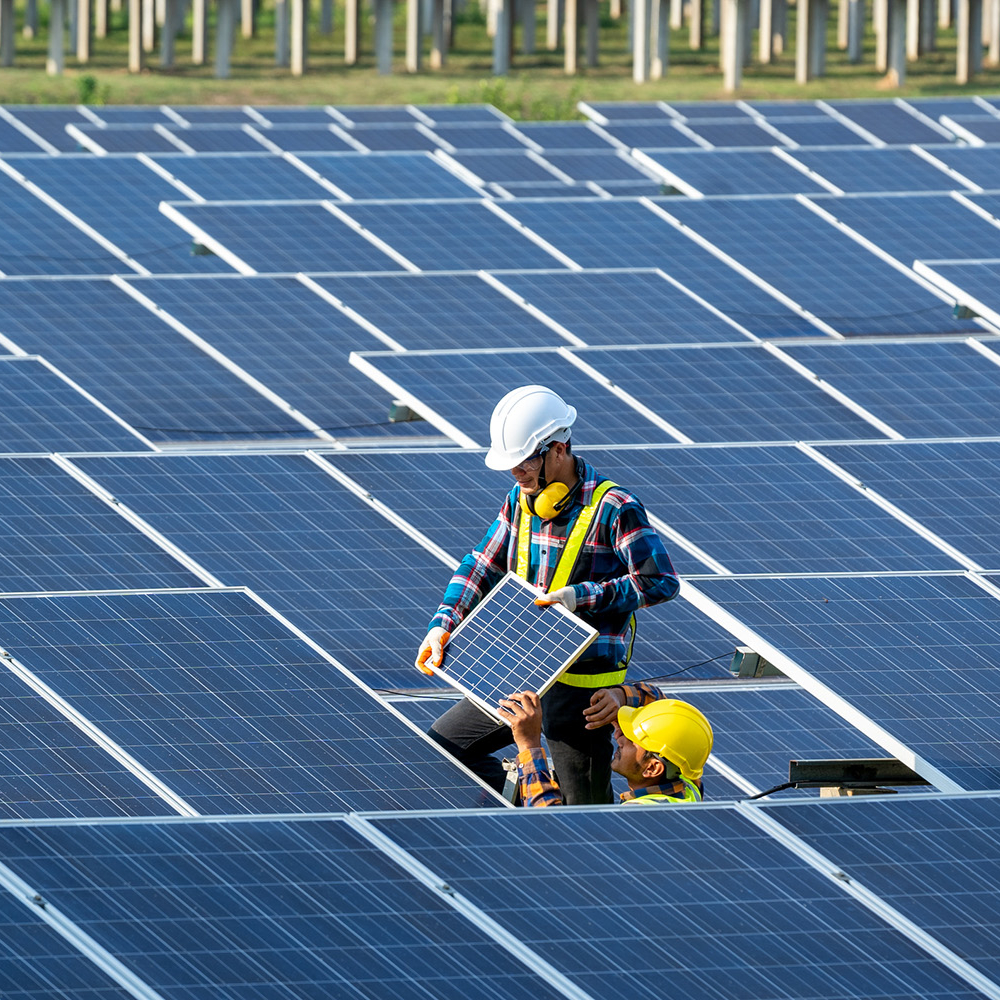 Two workers installing solar panels in Florida