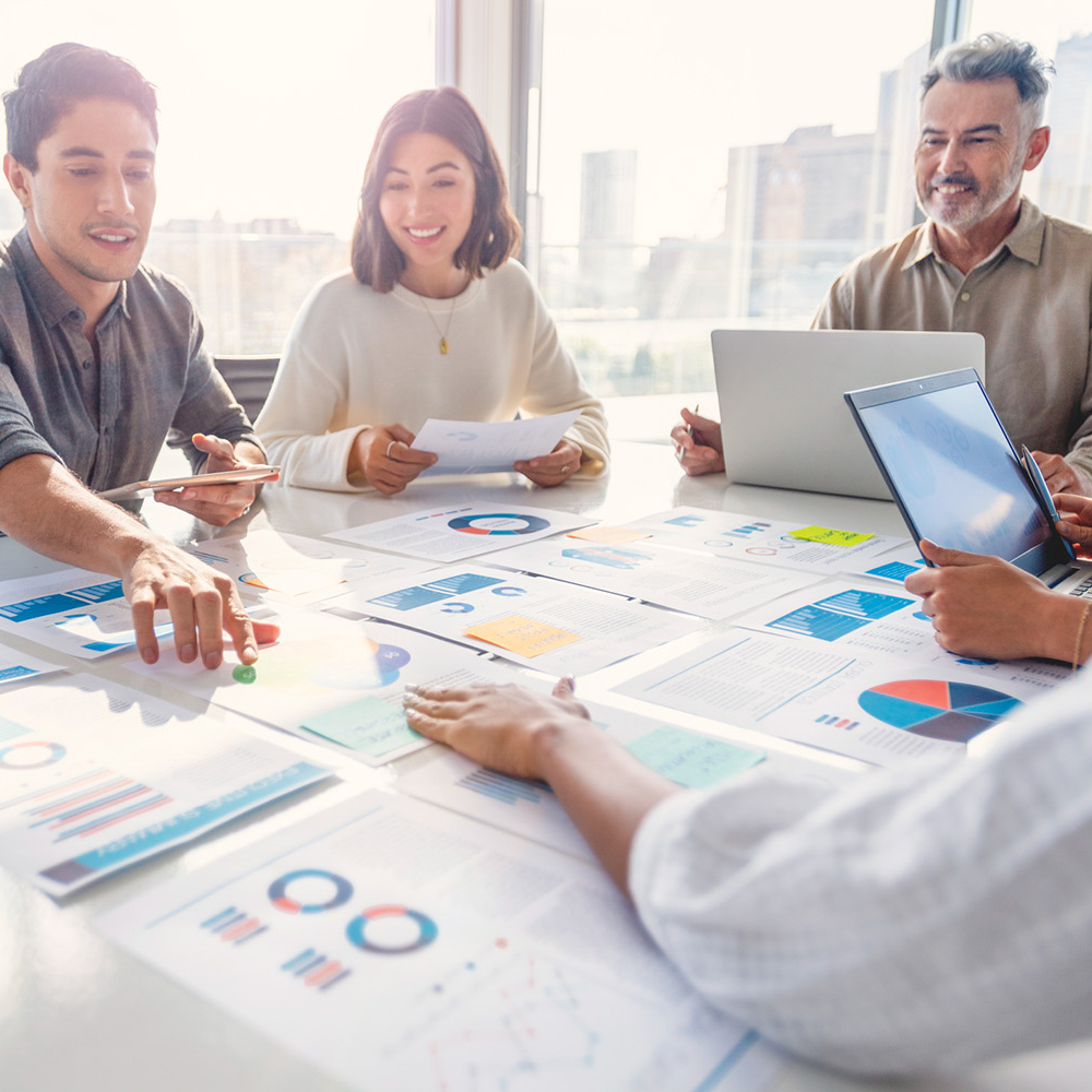 Group of Marketing professionals review graphs and data.