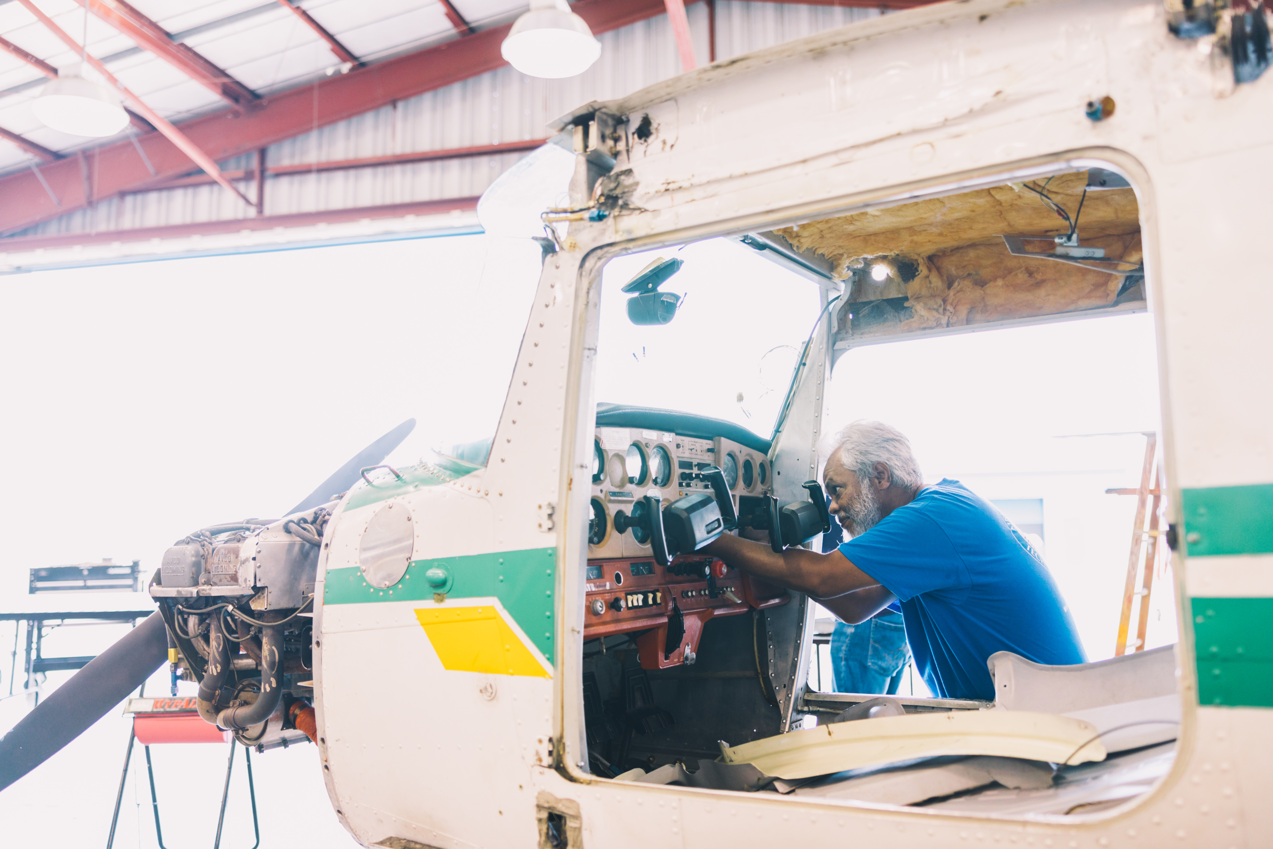 Man working on the inside of an airplane